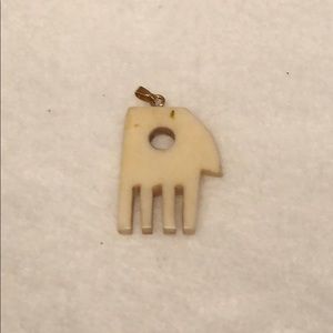 Carved fossilized ivory “hand” pendant